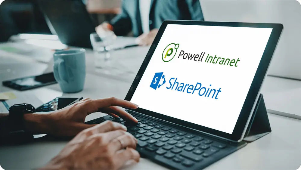 Laptop screen showing Powell Intranet and SharePoint logos